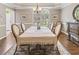 Elegant dining room with hardwood floors, a chandelier, and a large window at 420 Windswept Ct, Roswell, GA 30075