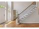Elegant foyer with hardwood floors, a staircase featuring wrought iron spindles, and a light neutral color palette at 420 Windswept Ct, Roswell, GA 30075