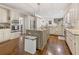 Bright kitchen boasts stainless appliances, granite countertops, kitchen island, and hardwood floors at 420 Windswept Ct, Roswell, GA 30075