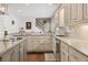 Well-lit kitchen with granite countertops, stainless steel appliances, white cabinets, and hardwood floors at 420 Windswept Ct, Roswell, GA 30075