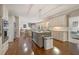 Open kitchen featuring stainless appliances, granite countertops, kitchen island, and hardwood floors at 420 Windswept Ct, Roswell, GA 30075