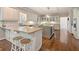 Spacious kitchen features a large island with wine rack, granite countertops, and hardwood floors at 420 Windswept Ct, Roswell, GA 30075