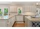 Bright kitchen featuring granite countertops, white cabinets, stainless steel appliances, and hardwood floors at 420 Windswept Ct, Roswell, GA 30075