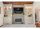Cozy living room with a fireplace, built-in shelving, and hardwood floors at 420 Windswept Ct, Roswell, GA 30075