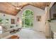 Inviting living room with vaulted wood ceilings, a large window, and fireplace at 420 Windswept Ct, Roswell, GA 30075