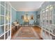 Elegant office with hardwood floors, a cozy rug, a cross, and bright windows with lots of natural light at 420 Windswept Ct, Roswell, GA 30075