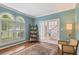 Charming office featuring arched windows, French doors, built-in shelving, and beautiful hardwood floors at 420 Windswept Ct, Roswell, GA 30075