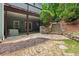 Lower-level patio area with stone paving and covered space, perfect for outdoor seating and enjoying the serene backyard at 420 Windswept Ct, Roswell, GA 30075
