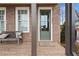Inviting brick front porch with a bench and an green front door, enhancing curb appeal at 4200 Legacy Ln # 22, Acworth, GA 30101