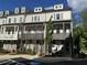 Exterior view of modern townhomes featuring individual balconies and covered front entries for stylish curb appeal at 4200 Legacy Ln # 22, Acworth, GA 30101