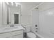 Clean, well-lit bathroom featuring a tiled shower-tub, white fixtures, and a modern vanity at 11255 Wittenridge Dr, Alpharetta, GA 30022