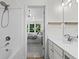 Bright bathroom with a shower-tub combination and vanity with a view to the main bedroom at 11255 Wittenridge Dr, Alpharetta, GA 30022