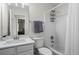 Clean, white bathroom featuring a sink, toilet, and shower-tub combo at 11255 Wittenridge Dr, Alpharetta, GA 30022