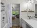 Well-lit bathroom with shower, bath and entrance to the bedroom at 11255 Wittenridge Dr, Alpharetta, GA 30022