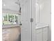 Bright bathroom with a modern vanity, window, and beautiful white door at 11255 Wittenridge Dr, Alpharetta, GA 30022