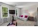 Bright bedroom with large windows, futon, and unique exercise bike setup at 11255 Wittenridge Dr, Alpharetta, GA 30022