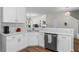 Well-lit kitchen with modern white cabinets, stainless steel appliances and breakfast bar at 11255 Wittenridge Dr, Alpharetta, GA 30022