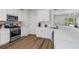 Bright kitchen with stainless steel appliances, white cabinets, and tile backsplash at 11255 Wittenridge Dr, Alpharetta, GA 30022