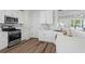 Modern kitchen features stainless steel appliances, white cabinets, and hardwood floors at 11255 Wittenridge Dr, Alpharetta, GA 30022