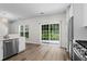 Sun-lit kitchen with stainless steel appliances and sliding glass door to the backyard at 11255 Wittenridge Dr, Alpharetta, GA 30022
