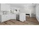 Bright kitchen features white cabinets, modern appliances, hardwood floors, and an open floor plan at 11255 Wittenridge Dr, Alpharetta, GA 30022