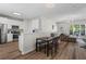 Modern kitchen and dining area with stainless steel appliances and hardwood floors at 11255 Wittenridge Dr, Alpharetta, GA 30022