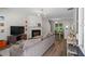 Cozy living room with a fireplace, hardwood floors, and lots of natural light at 11255 Wittenridge Dr, Alpharetta, GA 30022