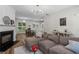 Inviting open-concept living area with a cozy fireplace and hardwood floors, leading to the dining area at 11255 Wittenridge Dr, Alpharetta, GA 30022