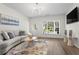 Cozy living room with hardwood floors, a comfortable sofa, and lots of natural light at 11255 Wittenridge Dr, Alpharetta, GA 30022