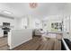 Open concept living space with hardwood floors connects the kitchen to the living room with a modern chandelier at 11255 Wittenridge Dr, Alpharetta, GA 30022