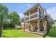 Backyard view showcasing a two-story covered deck, a patio, and a hot tub at 2370 Bradwardine Ct, Cumming, GA 30041
