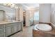 Elegant bathroom showcasing dual vanities, soaking tub, and decorative tile flooring at 2370 Bradwardine Ct, Cumming, GA 30041