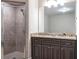 Bathroom featuring a tiled stand-up shower with a modern vanity at 2370 Bradwardine Ct, Cumming, GA 30041