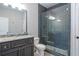Bathroom featuring a walk-in shower with dark gray subway tile and a pebble floor at 2370 Bradwardine Ct, Cumming, GA 30041