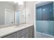 Bathroom showcasing a granite vanity and glass walk-in shower with decorative tile at 2370 Bradwardine Ct, Cumming, GA 30041