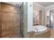Bathroom featuring a separate shower and soaking tub with decorative tile accents at 2370 Bradwardine Ct, Cumming, GA 30041