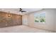 Large bedroom features a brick accent wall, modern lighting, and bright white windows at 2370 Bradwardine Ct, Cumming, GA 30041