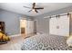 Bright bedroom features a ceiling fan and large sliding barn doors to the closet at 2370 Bradwardine Ct, Cumming, GA 30041