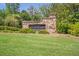 Stone entrance to The Cottages at Daves Creek, showcasing lush landscaping and established community at 2370 Bradwardine Ct, Cumming, GA 30041