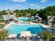 A luxurious community pool with slide, sun loungers, and seating areas at 2370 Bradwardine Ct, Cumming, GA 30041