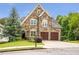 Beautiful stone home with manicured lawn, two-car garage, and mature landscaping at 2370 Bradwardine Ct, Cumming, GA 30041