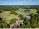 Scenic aerial shot of a community golf course with a pond and landscaped greens at 2370 Bradwardine Ct, Cumming, GA 30041