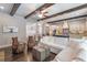 Open concept living room and kitchen featuring exposed beams, modern furniture, and stainless appliances at 2370 Bradwardine Ct, Cumming, GA 30041