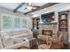 Inviting living room with a stone fireplace, beamed ceiling, and natural light at 2370 Bradwardine Ct, Cumming, GA 30041