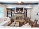 Cozy living room with a stone fireplace, built-in bookshelves, and beamed ceiling at 2370 Bradwardine Ct, Cumming, GA 30041