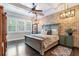 Main bedroom featuring a brick wall, a ceiling fan, and large windows with plantation shutters at 2370 Bradwardine Ct, Cumming, GA 30041