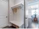 Mudroom featuring built-in bench with storage, coat hooks, and convenient access to the dining room at 2370 Bradwardine Ct, Cumming, GA 30041