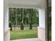 Picturesque backyard view from a covered porch, showcasing lush greenery, a fenced yard, and private wooded space at 2409 Malster Ln, Lawrenceville, GA 30043