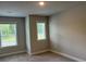 Neutral bedroom with two large windows providing lots of natural light, and plush carpet at 2409 Malster Ln, Lawrenceville, GA 30043