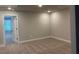 Spacious bedroom with carpet, neutral walls and baseboards, leading to another room behind an opened door at 2409 Malster Ln, Lawrenceville, GA 30043